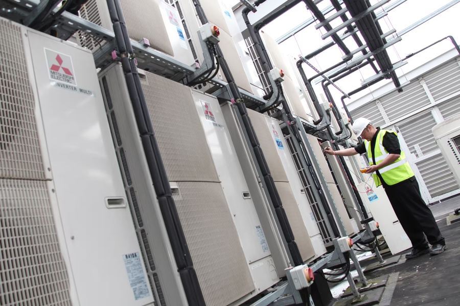 Engineer inspecting air conditioning units
